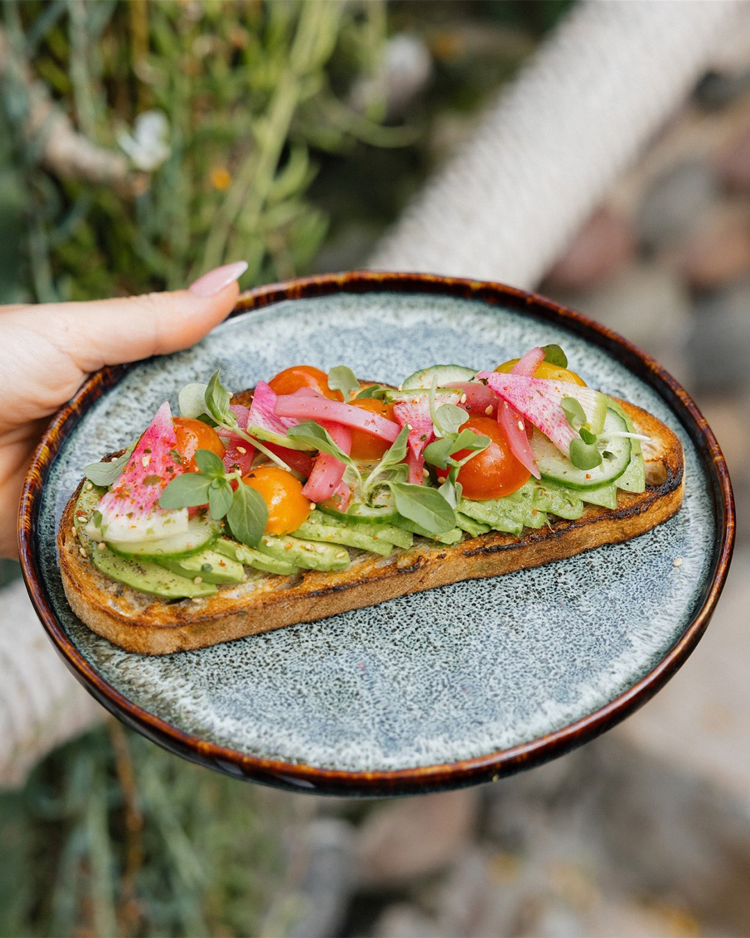 Avocado toast with heirloom tomato and pickled onion