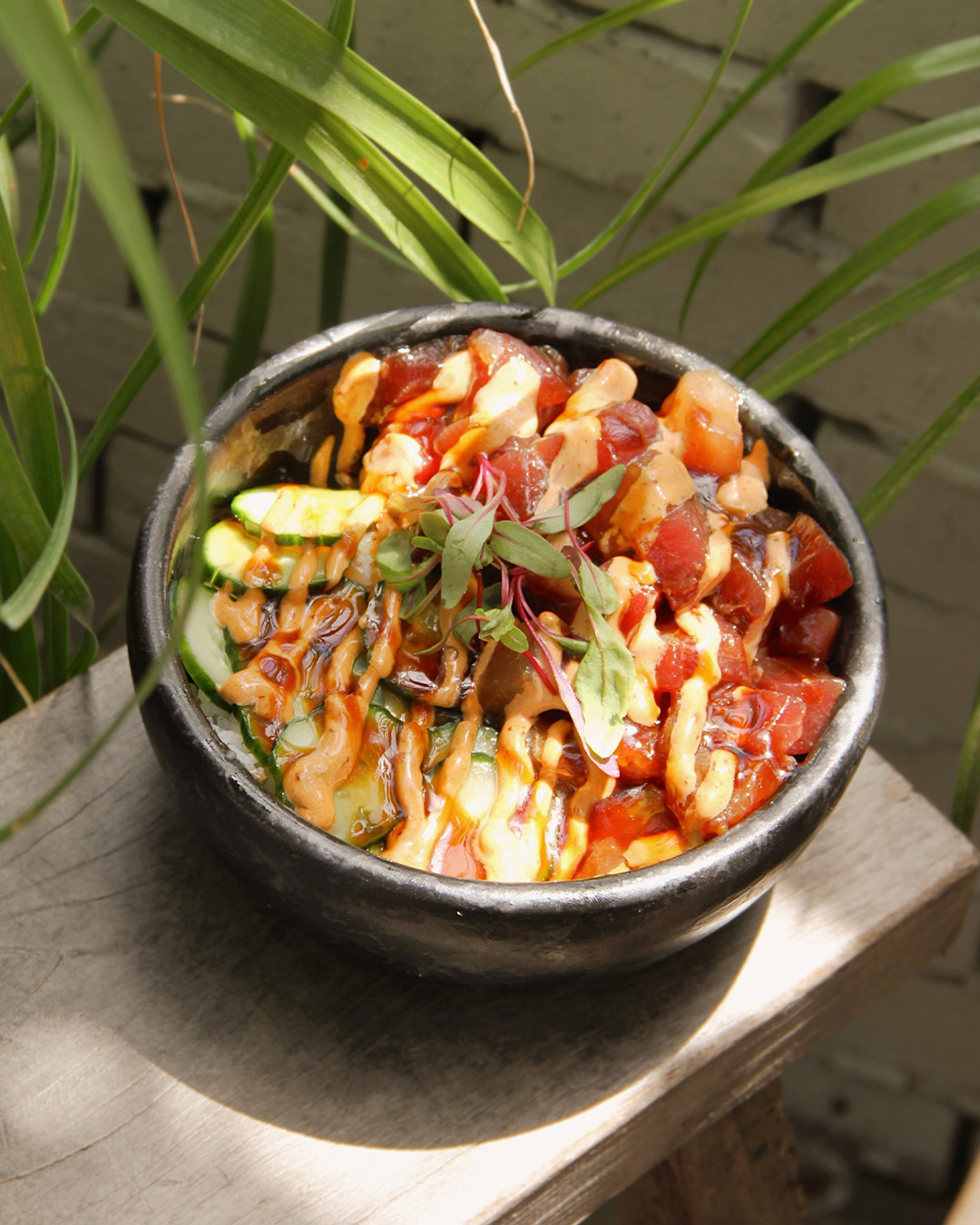 Tuna poke bowl with cucumber, micro greens and chilli crema