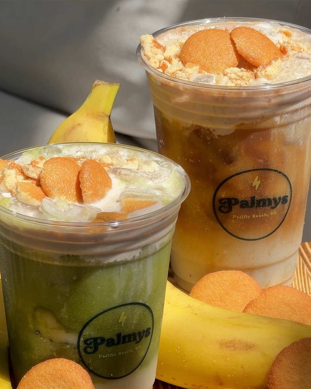 Two banana pudding smoothies topped with vanilla wafers